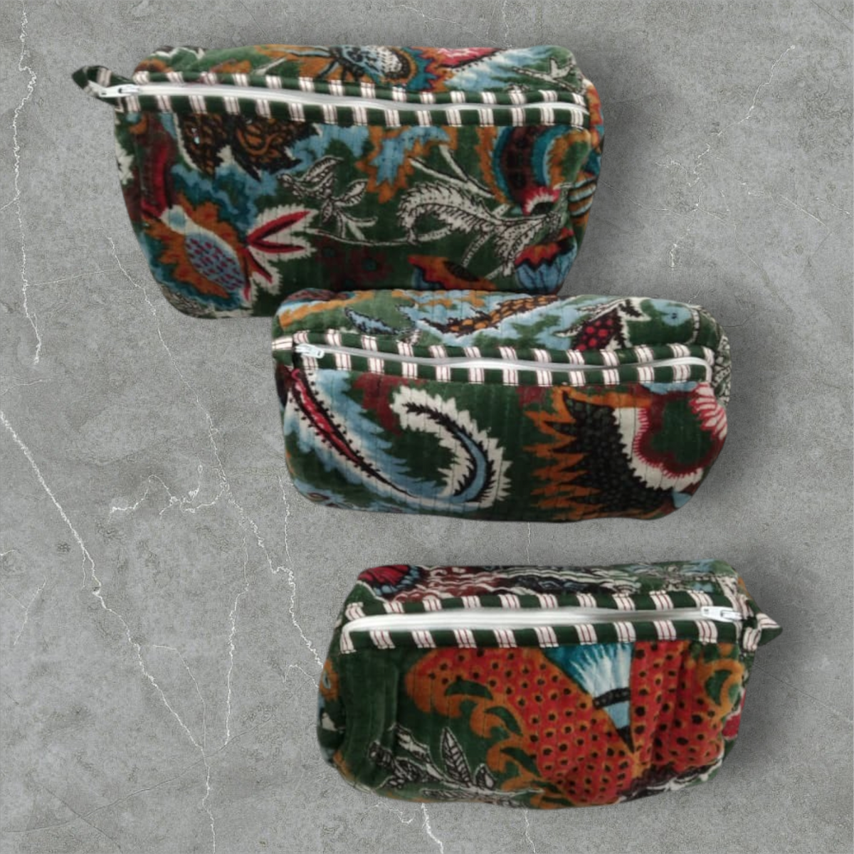 The Teal Thread set of 3 quilted cotton velvet vanity bags in wildflower green with floral prints and zipper closures.