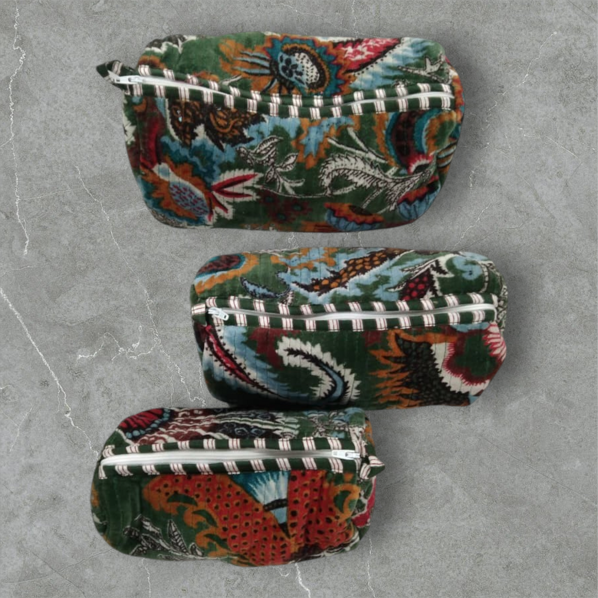 The Teal Thread set of 3 quilted cotton velvet vanity bags in wildflower green with floral print and white zippers.